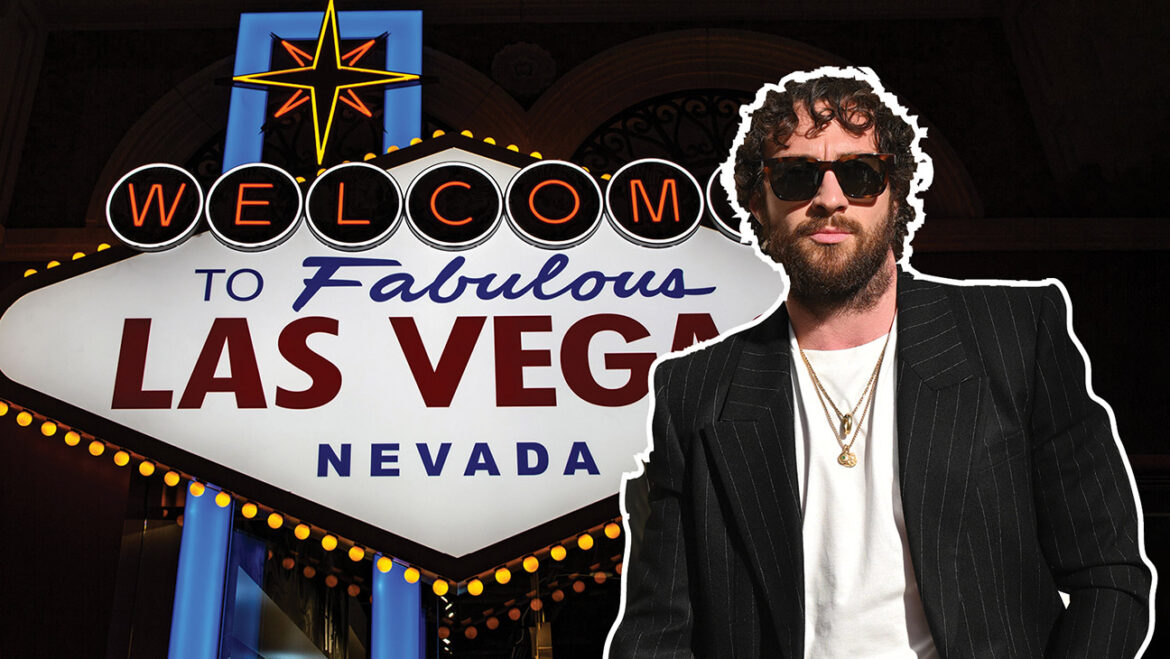 Aaron Taylor-Johnson in front of the Welcome to Las Vegas Sign