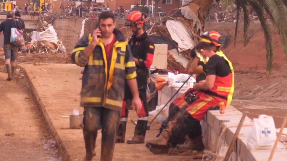 Spanish firefighters work through the night to remove mud left by flooding in outskirts of Valencia
