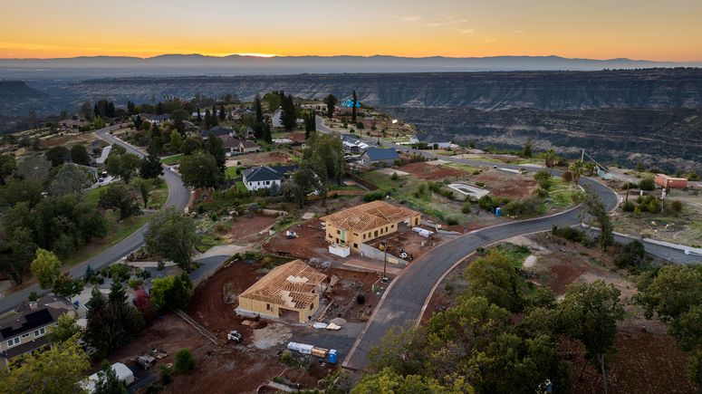 Image may contain: Road, Outdoors, Architecture, Building, Aerial View, Cityscape, Urban, Housing, Driveway, and House