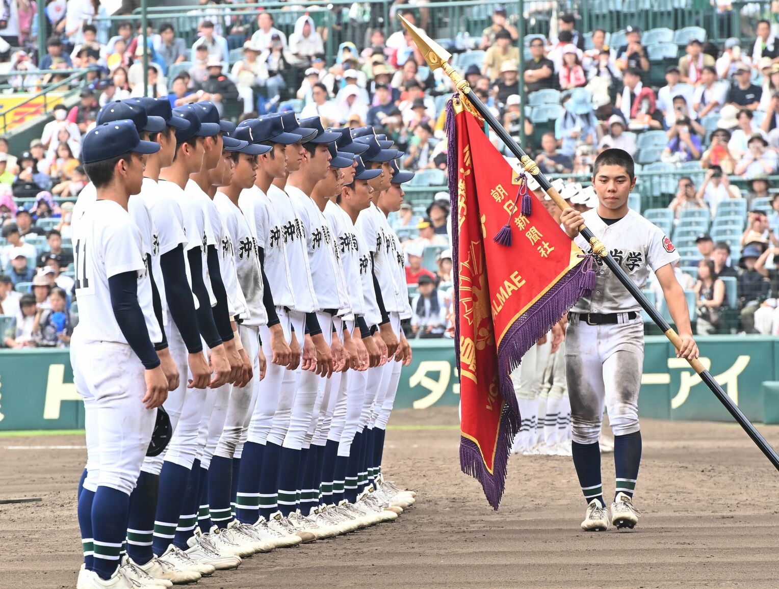 夏の甲子園を制し、深紅の優勝旗を手にする眞喜志拓斗主将（右）＝２３日、甲子園球場（小宮健撮影）