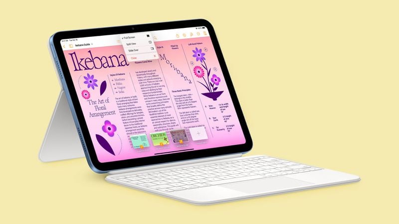 iPhoneIslam.com の、カラフルなグラフィックとテキストを含むデジタル生け花の本を表示するキーボード付きタブレット。