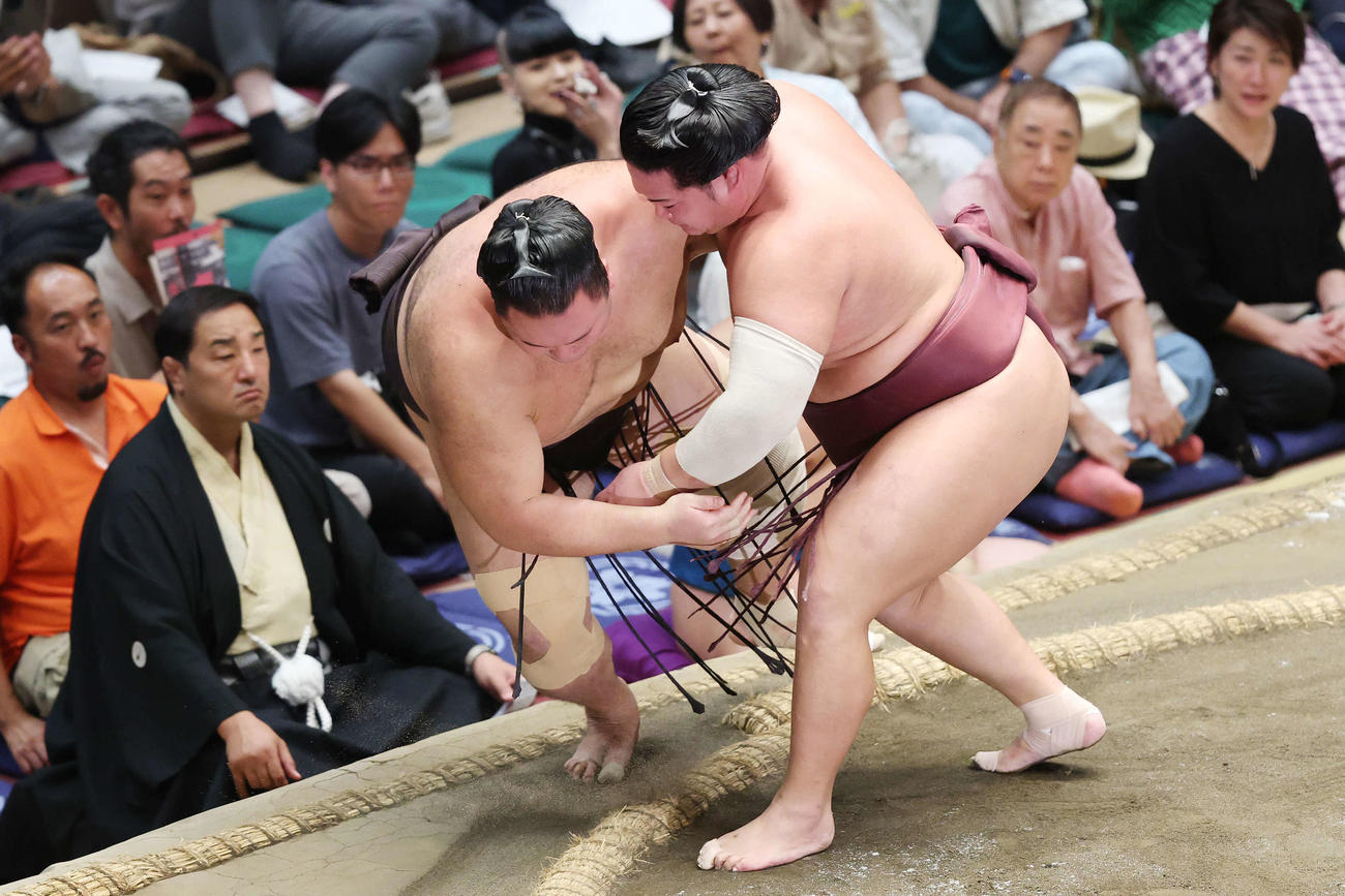 秋場所13日目、上手投げで朝乃山(左)を破る錦富士(撮影・宮地輝)